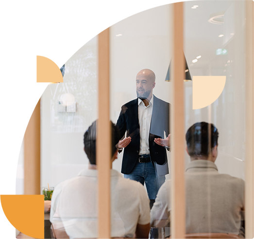 Colleagues listen thoughtfully to an explanation of a security awareness program during a company training session.